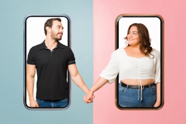 A plus size woman and man looking at each other romantically after communicating and dating online.